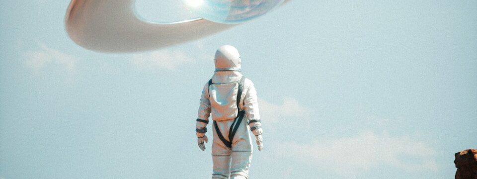 a man in a space suit standing on top of a rock